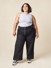 Load image into Gallery viewer, Lady wears the Rika Pants, front view with top-stitching detail in contrasting colour
