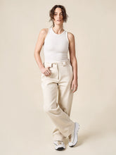 Load image into Gallery viewer, Lady wears the Rika Pants, long, straight leg,  front view, leg crossed in front of the other
