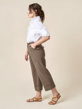 Load image into Gallery viewer, Side view of lady wearing Rika Pants, cropped leg version with turn up cuffs
