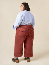 Load image into Gallery viewer,  Back view of lady wearing Rika Pants, cropped leg version with turn up cuffs, and patch pockets with flaps at hip level
