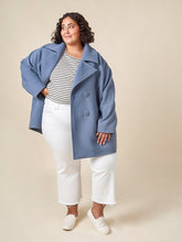 Load image into Gallery viewer, Model wears the shortened version of the Phoebe Coat, an double breasted coat at mid thigh length
