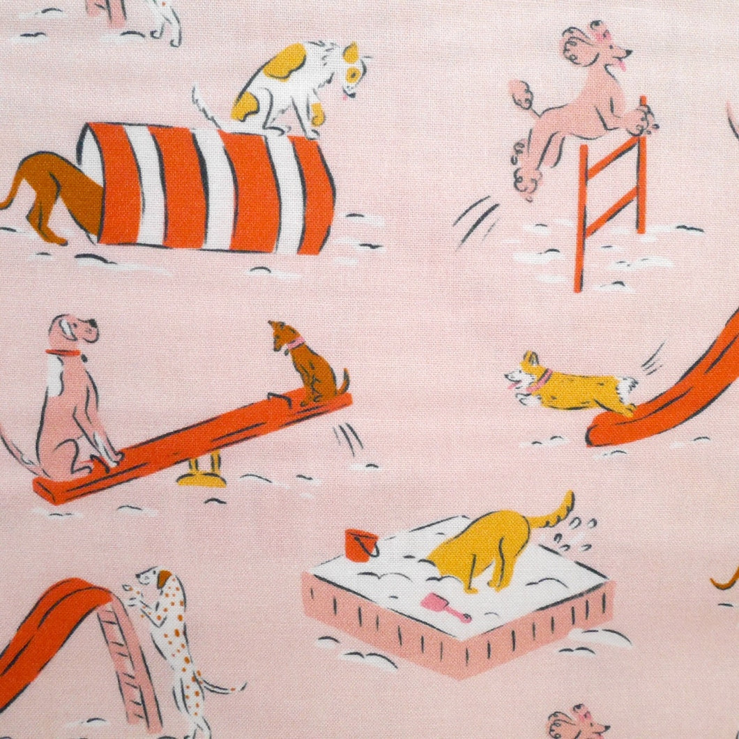 Close up of cartoon dogs playing on playground apparatus, print on cotton fabric