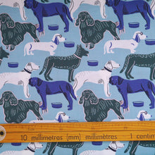 Load image into Gallery viewer, Organic Cotton Fabric with print of illustrated dogs displayed next to a wooden ruler
