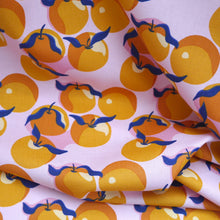 Load image into Gallery viewer, Organic cotton fabric with print of Clementines, gently folded in drape
