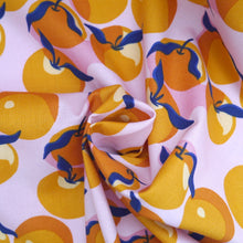 Load image into Gallery viewer, Organic cotton fabric with print of Clementines, displayed with central swirl
