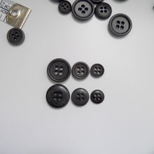 Load image into Gallery viewer, 4-hole corozo buttons shown in three different sizes, one side shows a smooth domed side, the other shows a flat with edged rim
