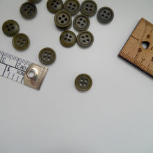 Load image into Gallery viewer, Corozo button with 4 holes, displayed amongst tape measure and ruler
