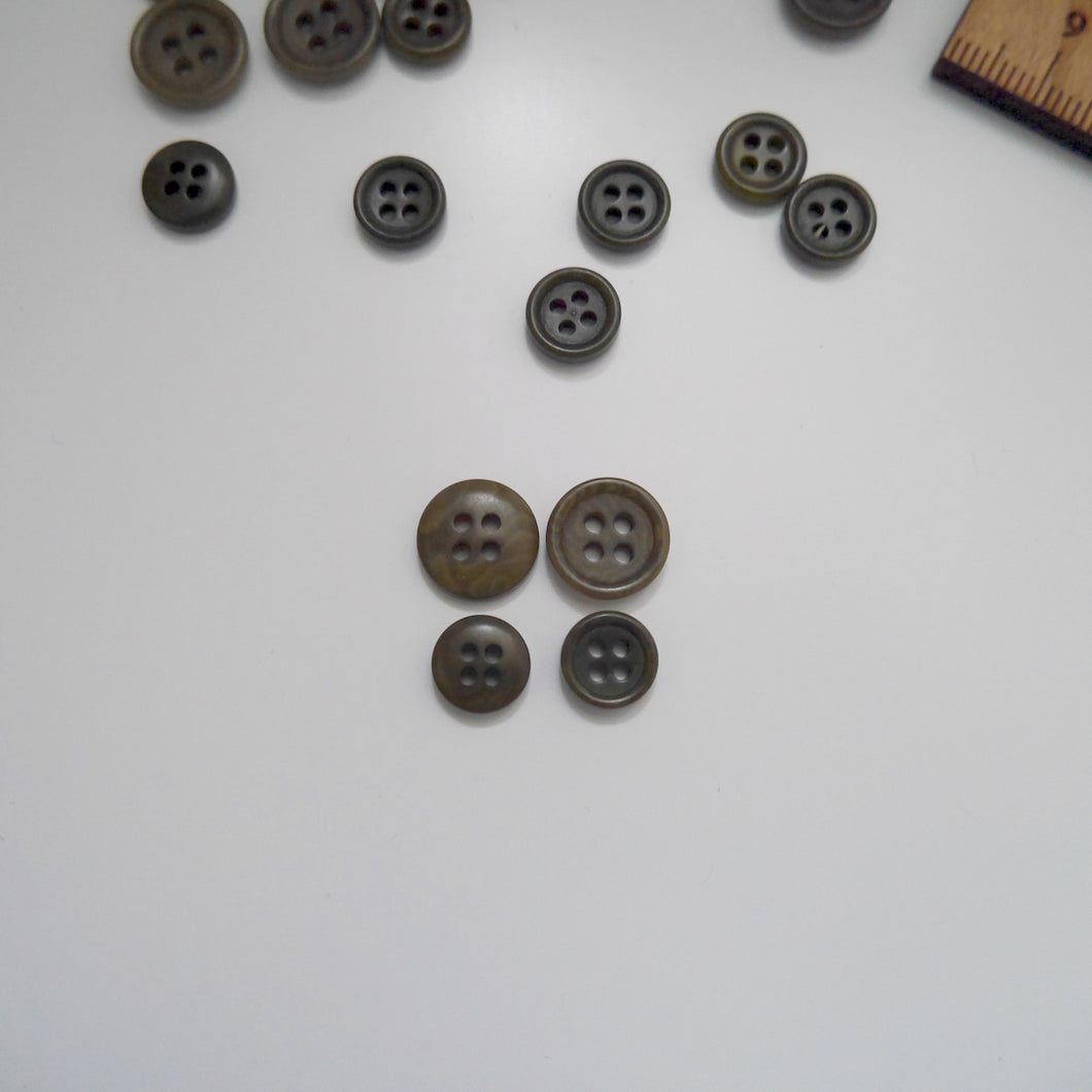 4-hole corozo buttons shown in two different sizes, one side shows a smooth domed side, the other shows a flat with edged rim