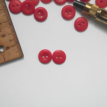 Load image into Gallery viewer, Two 2-hole corozo buttons, one showing smooth dome side, the other showing concave side
