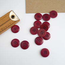 Load image into Gallery viewer, Scattering of 4-hole buttons displayed next to wooden ruler
