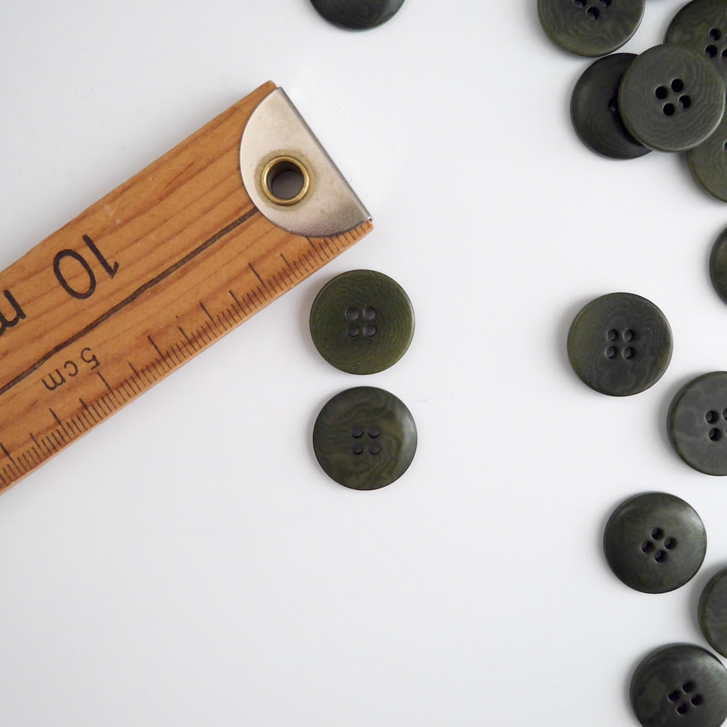 Two 4-hole buttons displayed, one with flat side, the other domed