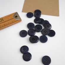 Load image into Gallery viewer, Scattering of 4-hole buttons displayed next to wooden ruler
