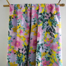 Load image into Gallery viewer, EcoVero viscose fabric with painted flowers print hangs in drape
