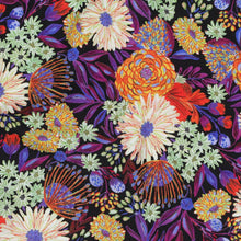 Load image into Gallery viewer, Eco Viscose fabric with a vibrant floral print lays flat, close up of print
