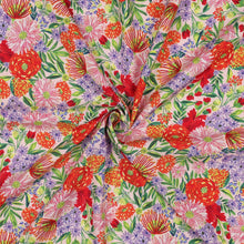 Load image into Gallery viewer, Viscose fabric with vibrant, floral print, shown with a central twist to show soft fluid drape
