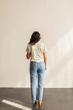 Load image into Gallery viewer, Back view of lady standing wearing a short sleeve Donny shirt

