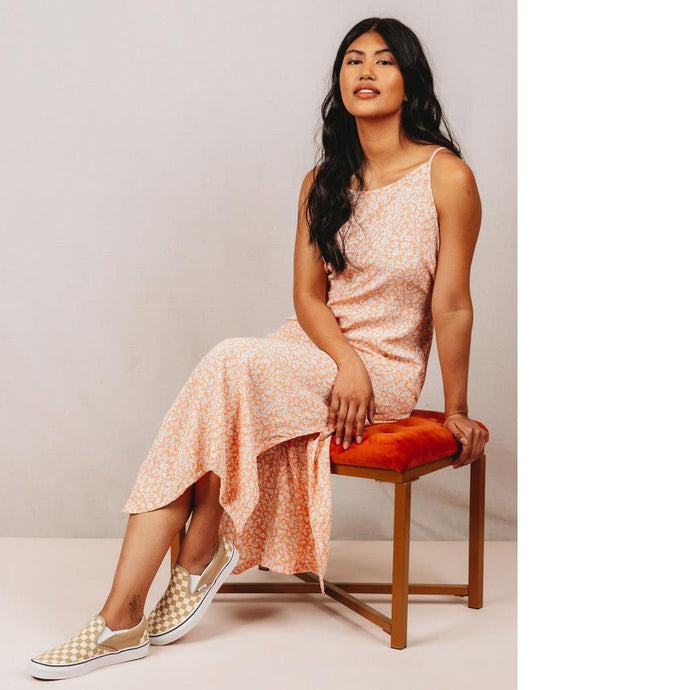 Lady perches on stool, wears a calf-length Saltwater Slip Dress