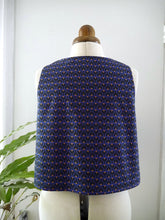 Load image into Gallery viewer, Back view of a sleeveless vest with a small repeating geometric pattern displayed on a mannequin.

