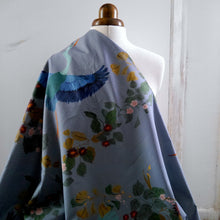 Load image into Gallery viewer, Cotton fabric with pattern print of large heron in flight amongst leaves, displayed draped on mannequin
