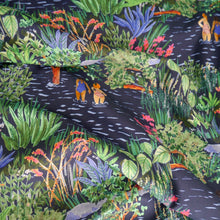Load image into Gallery viewer, Cotton lawn fabric shown in soft drapes, with a vibrant print featuring bathers, plants, and flowers in a lake
