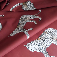 Load image into Gallery viewer, Cotton lawn fabric with leopards print, shown with soft folds
