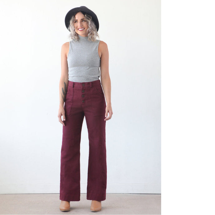 Lady wears The Lander Pant from True Bias, bootcut, highwaisted with visible button fly, and side patch pockets