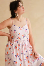 Load image into Gallery viewer, Lady wears a strappy v-neck dress made up in Limonade Viscose fabric
