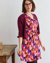 Load image into Gallery viewer, Lady wears a short, V-neck dress made with Lise Tailor Fairytale Viscose fabric
