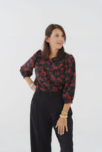 Load image into Gallery viewer, Model wearing a patterned blouse, made with Celestial Viscose fabric, stood in front of a plain background
