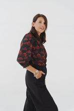 Load image into Gallery viewer, Model wearing a floral blouse, made with Celestial Viscose fabric, stood in front of a plain background
