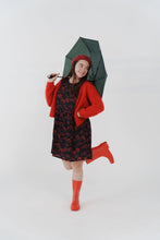 Load image into Gallery viewer, Model wears knee length dress, made with Celestial Viscose fabric, worn with knitted cardigan, holding umbrella
