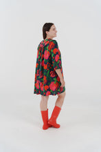 Load image into Gallery viewer, Woman wearing a colourful floral, a-line dress, made with La Roseraie Viscose fabric

