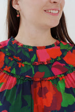 Load image into Gallery viewer, Close-up of a person wearing a colourful floral dress with ruffled collar, made with La Roseraie Viscose fabric
