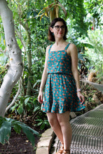 Load image into Gallery viewer, Lady stands amongst trees and plants, wearing a 2-piece bodice and skirt made with the Evergreen design Viscose fabric
