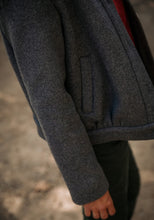 Load image into Gallery viewer, Close up of welt pocket at a diagonal, on bottom of jacket
