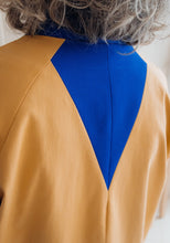 Load image into Gallery viewer, Back view of lady wearing Nage Libre jacket, showing back triangular panels
