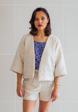 Load image into Gallery viewer, Lady stands wearing cropped version of Nage Libre jacket, above-hip length

