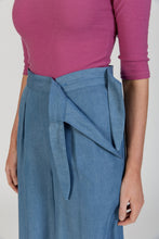 Load image into Gallery viewer, Close up detail of lady wearing Flint trousers at waist, shows a concealed side flap closure
