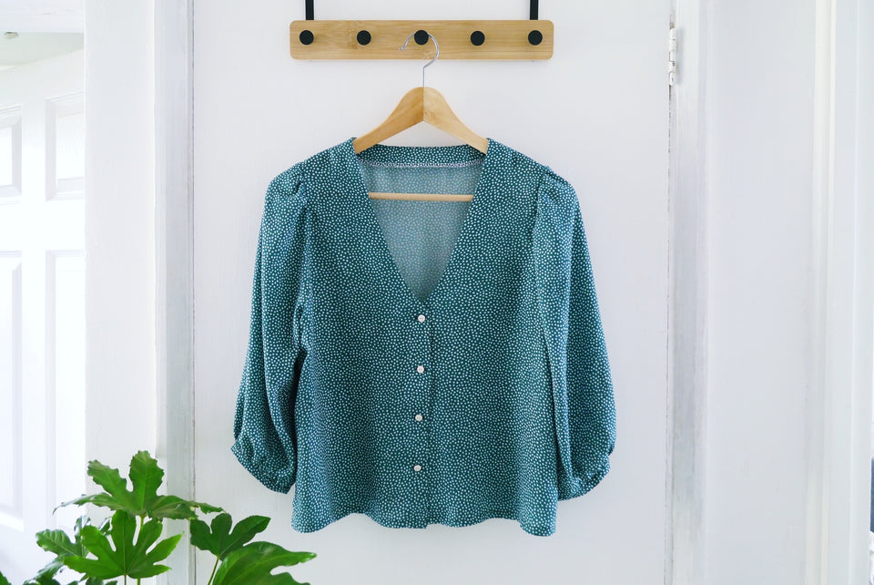 EcoVero blouse hung on a hanger