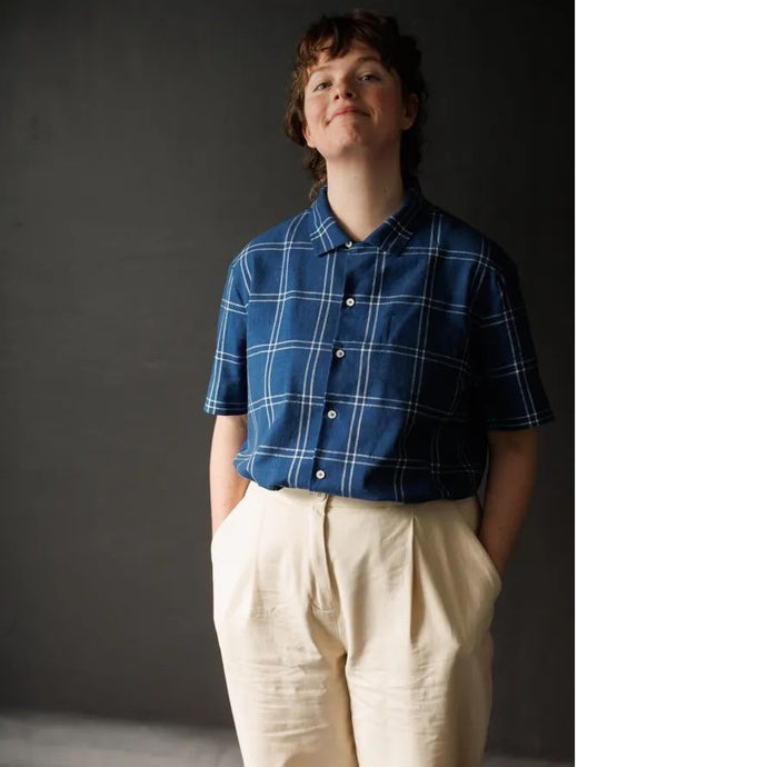 Model wears collared, box-fit, short-sleeved shirt