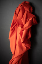 Load image into Gallery viewer, Bolt of organic cotton hemp fabric stood against wall with fabric draped over itself
