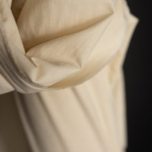 Load image into Gallery viewer, Close up of Organic Cotton Hemp Fabric draped over end of bolt, shows plain weave
