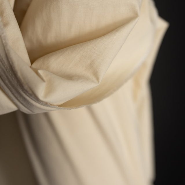 Close up of Organic Cotton Hemp Fabric draped over end of bolt, shows plain weave