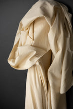 Load image into Gallery viewer, Bolt of Organic Cotton Hemp Fabric stood against wall with fabric draped over the top end
