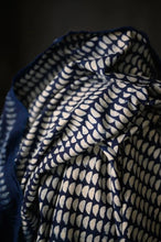 Load image into Gallery viewer, Close up of Indigo, organic cotton fabric with white geometric handblock pattern
