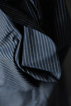 Load image into Gallery viewer, Close up of draped pinstripe fabric on a bolt
