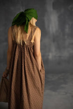 Load image into Gallery viewer, Back view of model wearing a sleeveless dress, gathered dress. Hand in side seam pocket
