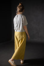 Load image into Gallery viewer, Back view of model in motion wearing Juno culotte trousers
