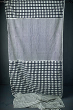 Load image into Gallery viewer, Organic cotton fabric hangs shows a handblock print of four different patterns
