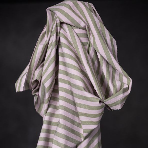 Striped, organic cotton/linen fabric with green and pink stripes on a black background